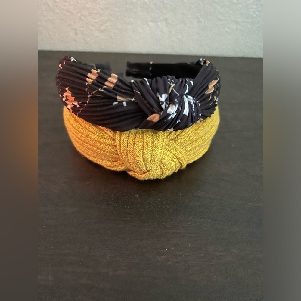 Two knot top headbands. One floral, one yellow.